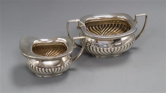 A late Victorian demi fluted silver cream jug and matching sugar bowl, William Hutton & Sons, London, 1899, 14.5oz.